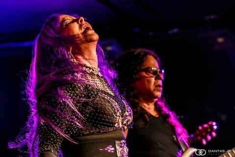 Baby do Brasil fechando os olhos e jogando a cabeça pra trás com cabelos lilás em movimento durante show no Blue Note Rio por Dantas Jr.'