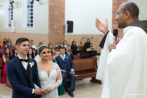 noivos e padre durante casamento'