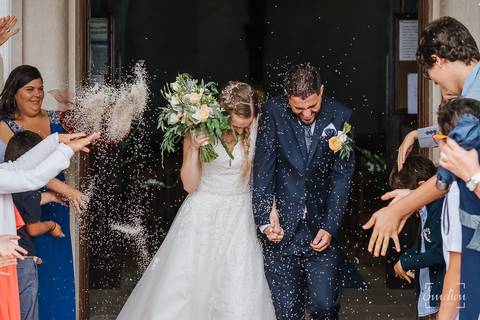 Convidados jogam arroz aos noivos na saída da igreja de Febres.'