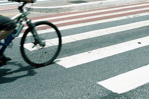Ciclista na Av. Paulista na faixa de pedestres'