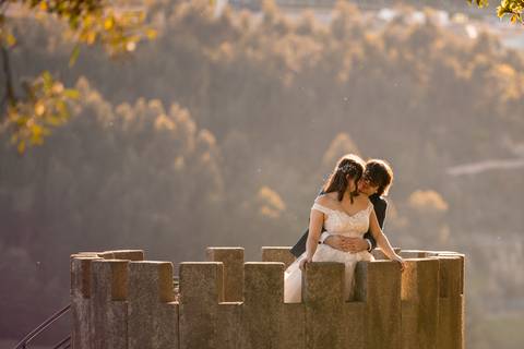 Casal abraçado em cima de uma torre'
