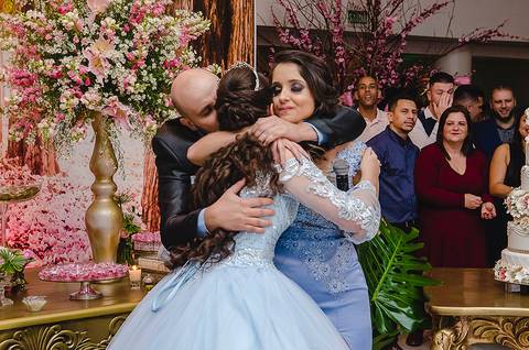 Debutante recebe o abraço dos pais'