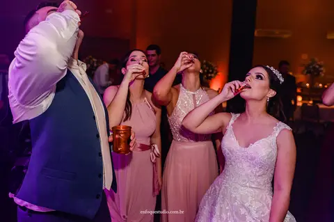 Noivos Gabriela e Guilherme brindando com shots na pista de dança junto aos convidados na festa de casamento em Itu.'