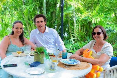 Momentos de carinho e união entre gerações durante o batismo em Praia do Forte, captados por Waldyr Lantyer.'