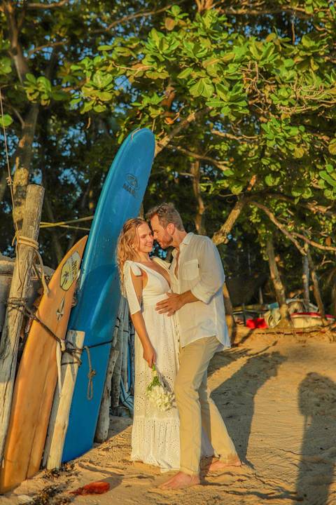 O que fazer em Praia do Forte Bahia, Fotógrafo em PRAIA DO FORTE BAHIA, WALDYR LANTYER Noivos caminhando na areia da Praia do Forte durante o pôr do sol, celebrando um casamento intimista na praia na Bahia.'
