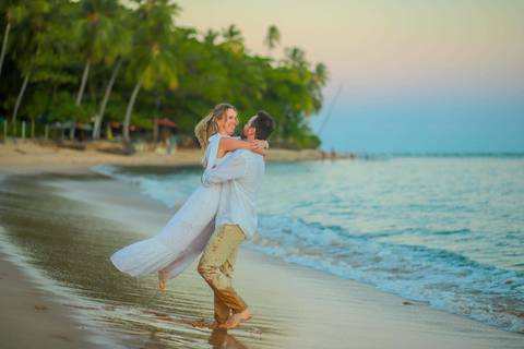 O que fazer em Praia do Forte Bahia, Fotógrafo em PRAIA DO FORTE BAHIA, WALDYR LANTYER. Casamento na praia ao pôr do sol com os noivos celebrando o amor em cenário natural na Praia do Forte, Bahia.'