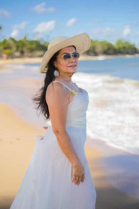 Retrato à beira da piscina de borda infinita do Tivoli EcoResort, com vista aberta para o mar e deques em madeira que se misturam à paisagem — um dos momentos mais bonitos do ensaio fotográfico de aniversário de 60 anos em Praia do Forte, litoral norte da'