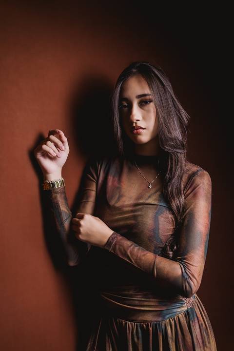 Retrato aproximado de Layla em uma composição com luz e sombra, durante seu ensaio fotográfico de 18 anos.'