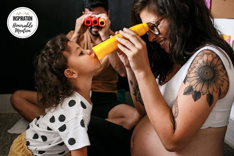 Foto de Adriana Costa de uma família à espera de um bebê brincando entre si  recebeu menção honrosa pela Inspiration Family Awards Collection 20