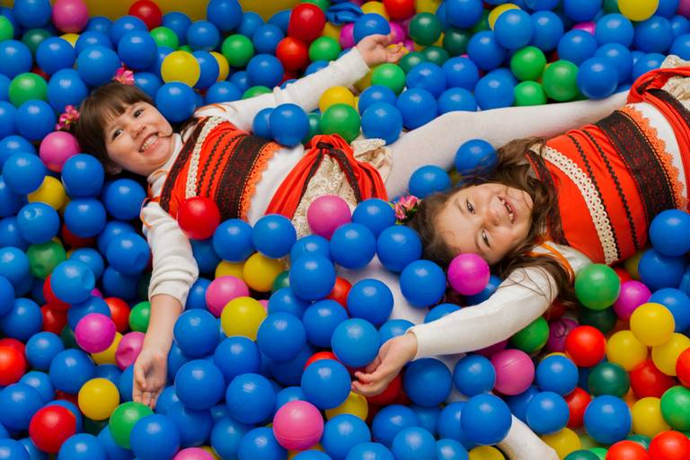 Gabi e Isadora, aniversariantes, deitadas na piscina de bolinhas 