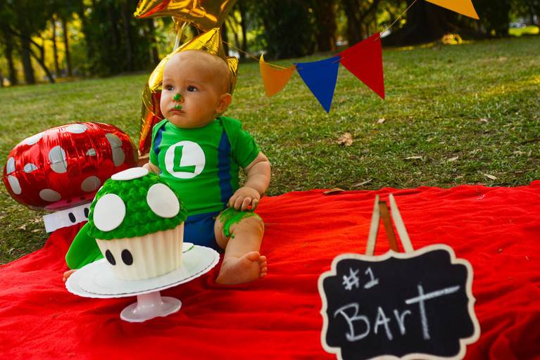 Bebê de um aninho vestido de Luigi do Super Mario Bros em Smash The Cake no Aterro do Flamengo no Rio de Janeiro