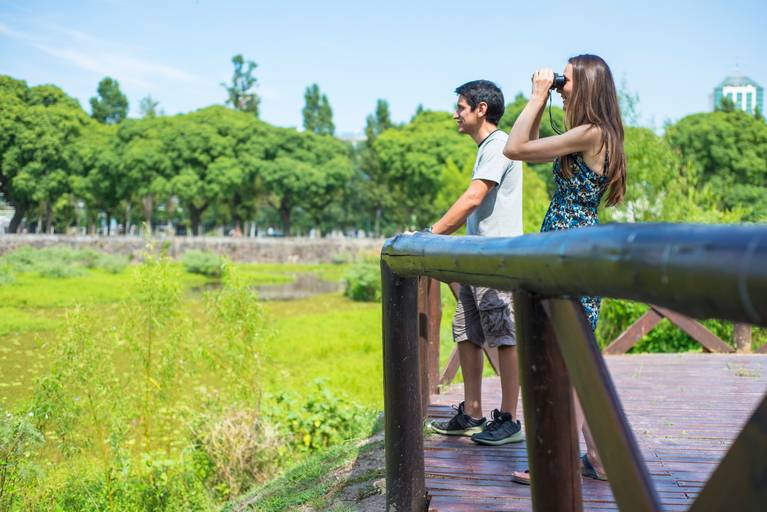 Novia mira por binoculares. Sesión pre boda en la Costanera Sur, CABA. Reserva ecológica. Marcos Pasquare Fotógrafo de Bodas.