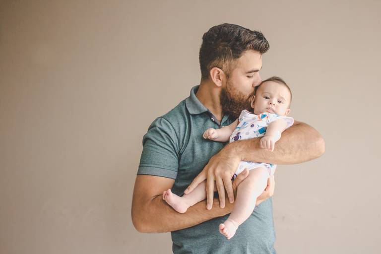 pai beijando bebe sessão em casa