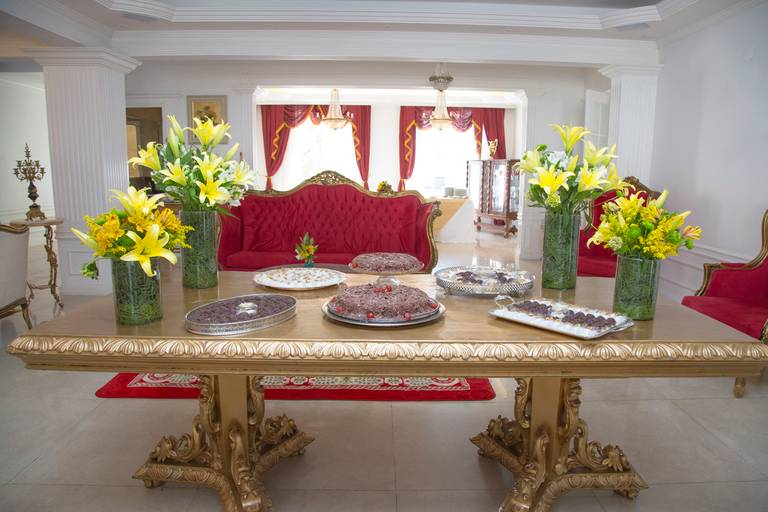 Mesa elegantemente decorada para uma festividade, com arranjos e detalhes temáticos.