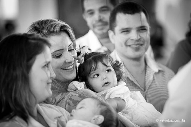 madrinha segurando a afilhada para o batismo