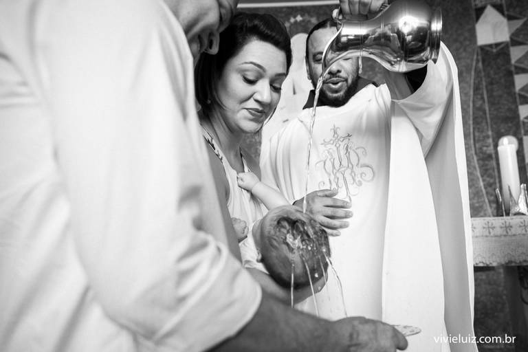 padre batizando a criança com água 