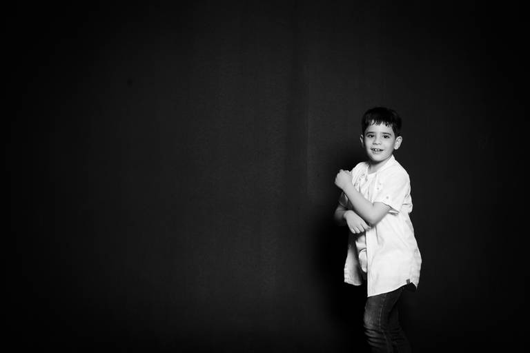 criança de braços cruzados sorrindo