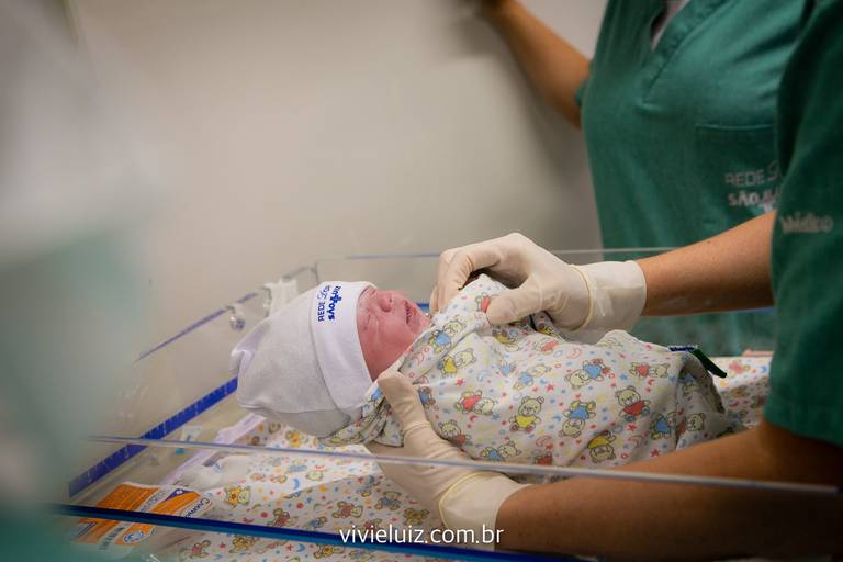 bebê recém nascido colocando roupa