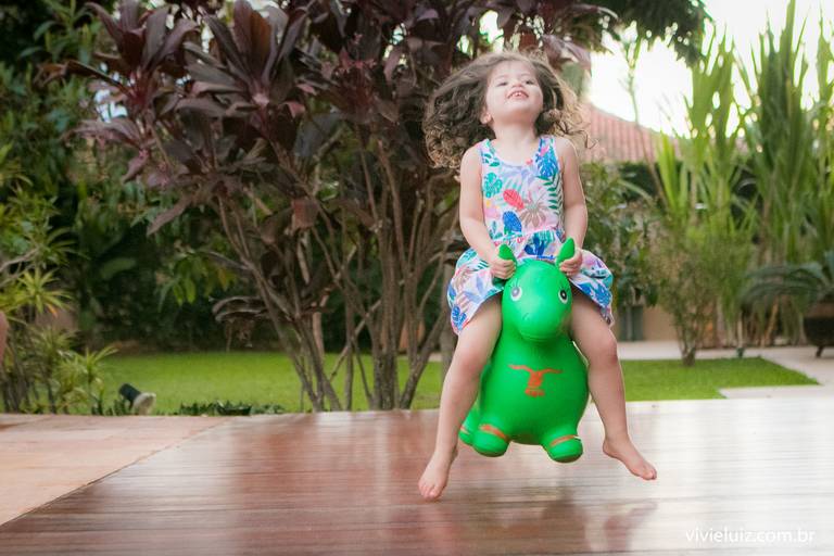 menina pulando no brinquedo