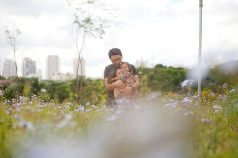  mãe e padrasto abraçados com a filha durante ensaio de família no Parque Villa Lobos, Pinheiros, Zona Oeste, São Paulo