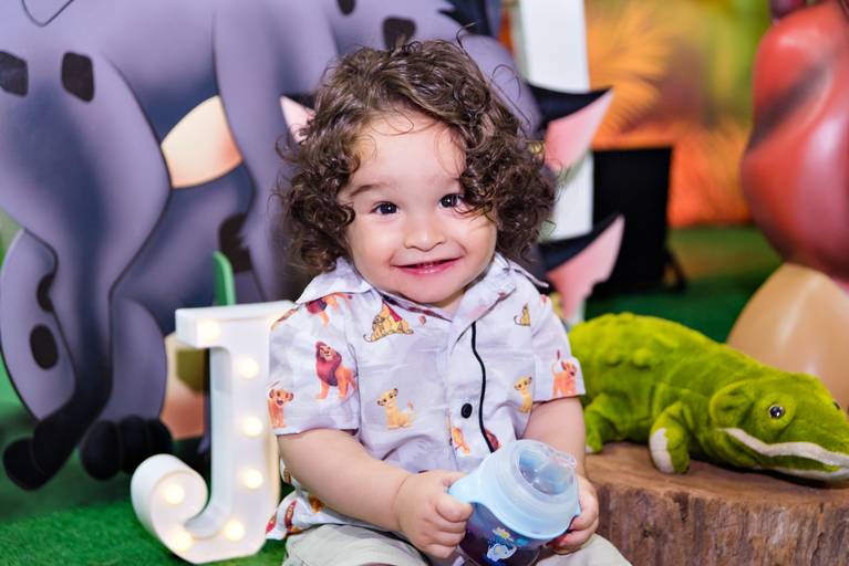 Aniversariante tomando suco em sua festa de um ano