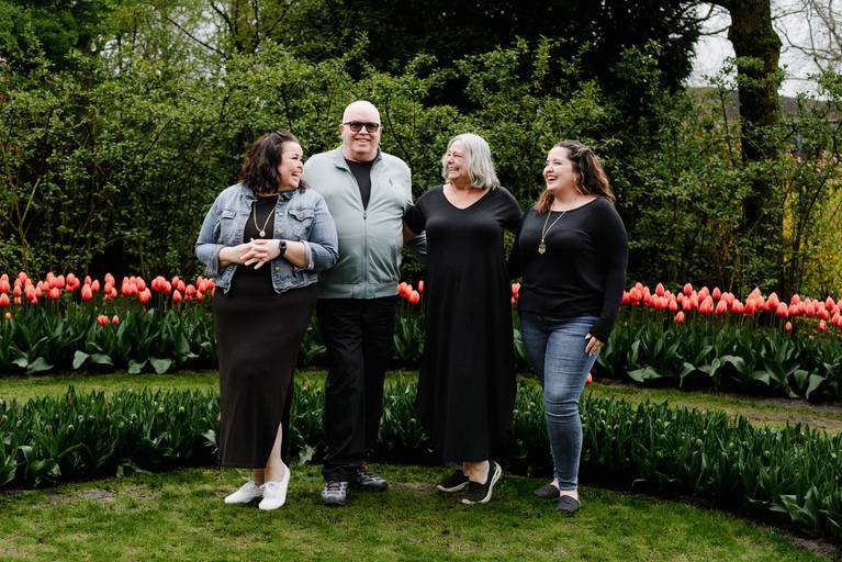 Family on a tulip-season shore excursion posing for vacation photos at Keukenhof Gardens near Amsterdam, ideal activity for river cruise passengers seeking professional photography.