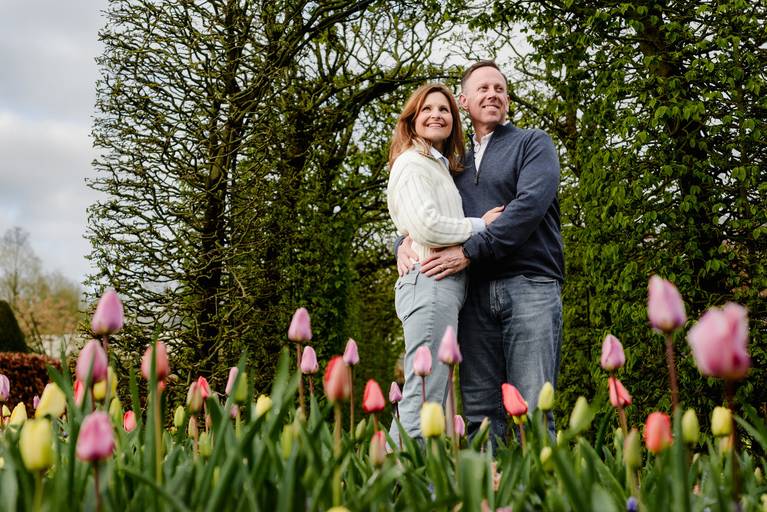 Romantic photo of a couple posing among colorful tulips at Keukenhof Gardens. A popular experience for travelers who want vacation photography during their visit to Holland in spring