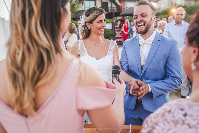 Noivos sorrindo durante a cerimonia de casamento na praia de Bombinhas SC