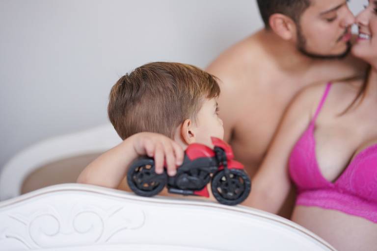 Ensaio gestante life style fotografado pelo melhor fotógrafo de ensaios de campo largo e Curitiba, Michel Druziki. Filho mais velho brincando e pais se beijando