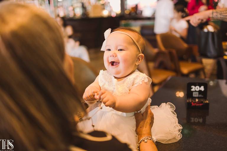 bebê rindo para mãe em festa batizado - fotografa em sbc