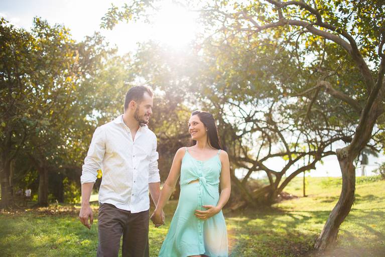 ensaio de gestante externa, ao ar livre, em soturno, cachoeiro de itapemirim, espirito santo. Book de gestante com marido andando de mãos dadas e olhando um para o outro.